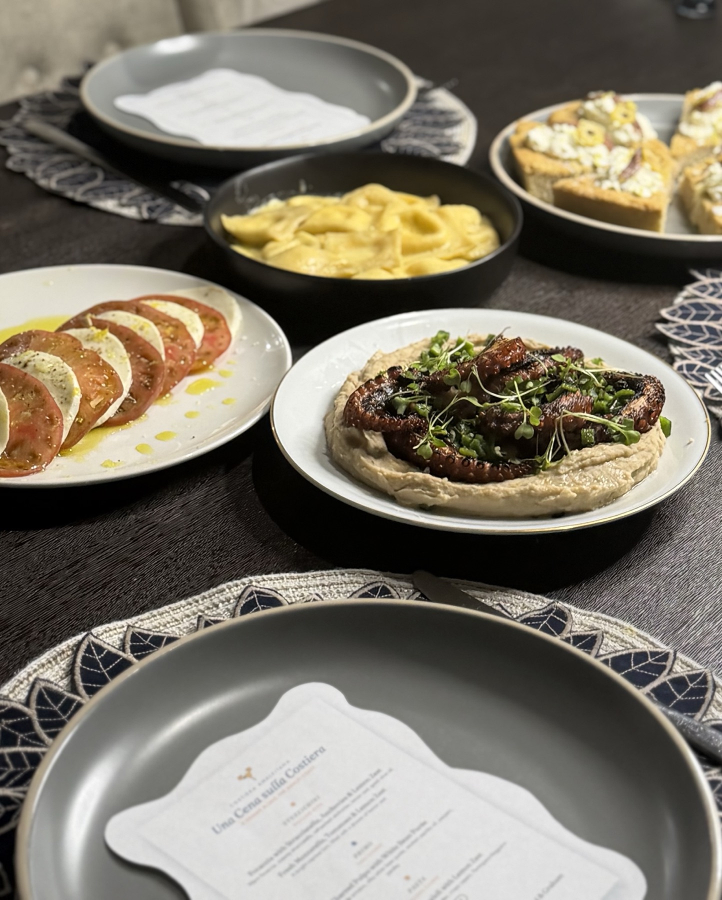 Grilled octopus over white bean puree, table spread