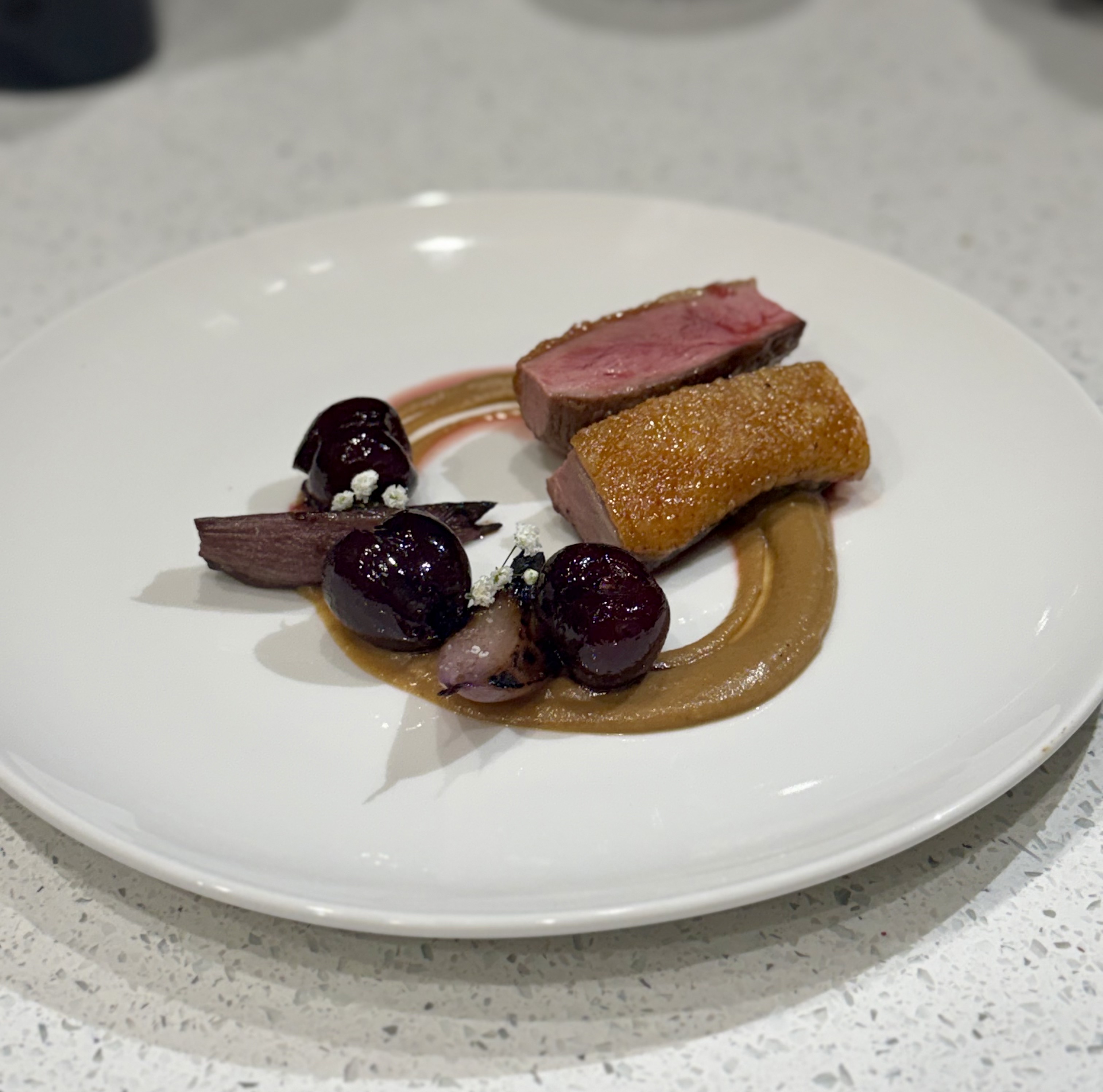 Seared duck breast with brandied cherries and pear purée