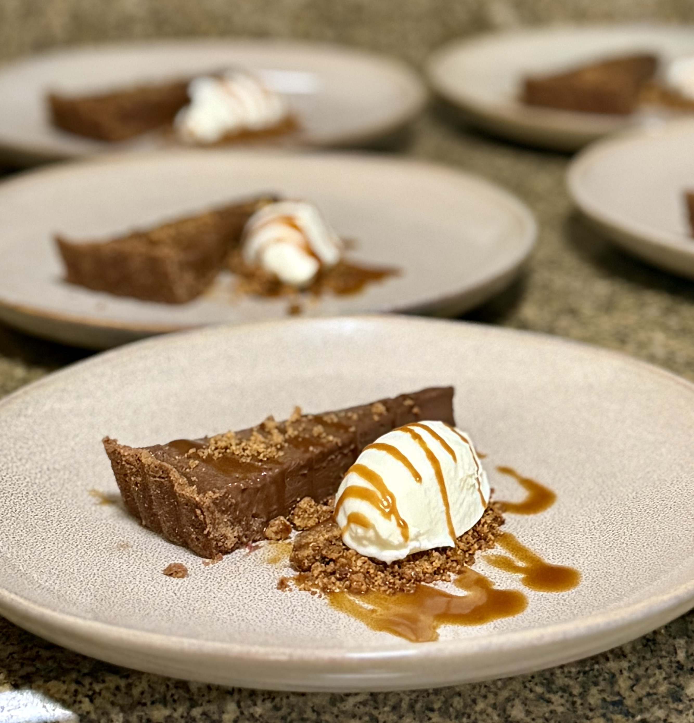 Chocolate tart with vanilla ice cream and caramel drizzle